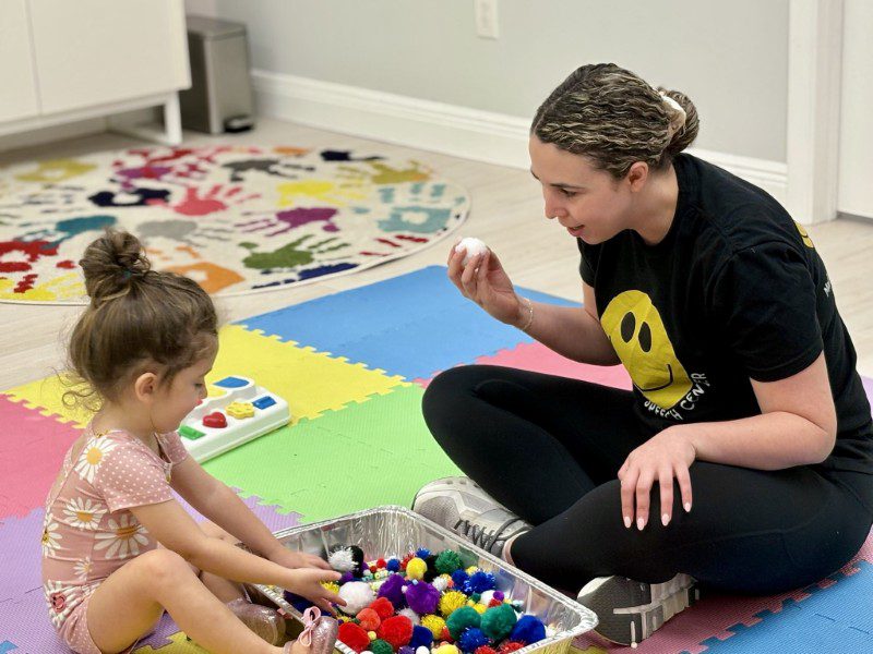 Madison Levine of Madison Speech Center working with a little girl.