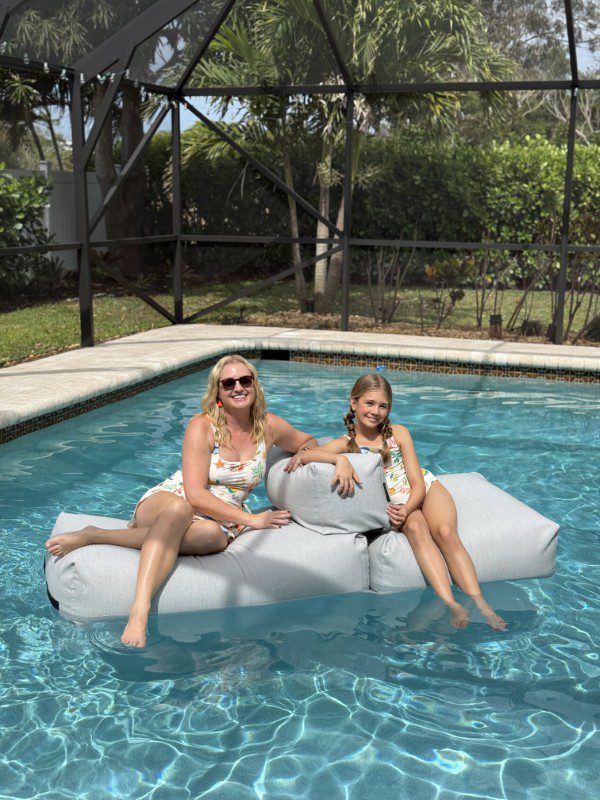 Modern Boca Mom and daughter Avery floating in the pool