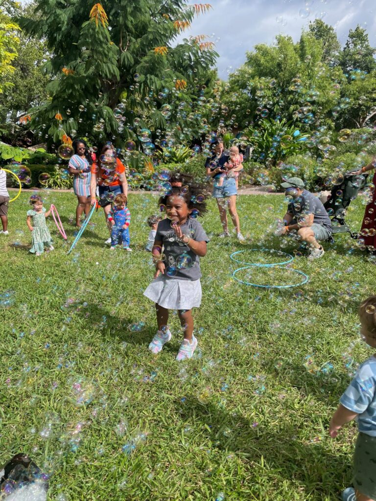 Girl Playing in Bubbles scaled